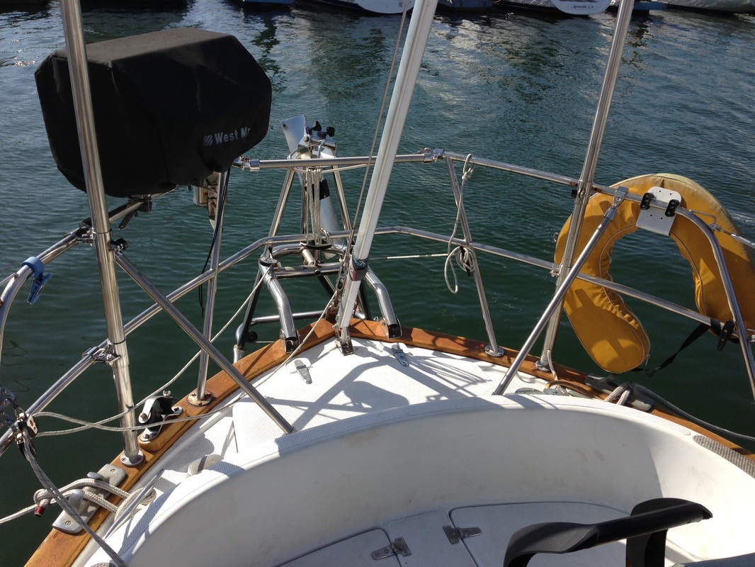 struts added to stern rails on sailboat to increase strength of marine solar panel pole
